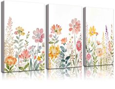 three canvases with flowers painted on them, one in white and the other in pink