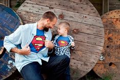 a man sitting next to a little boy