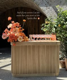 an outdoor bar with flowers and candles on it