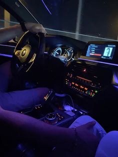 the interior of a car is lit up with blue lights and steering wheel, as well as dashboard controls