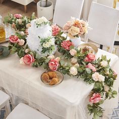 a table with flowers and plates on it