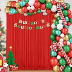 a christmas themed stage set up with balloons, candy canes and other holiday decorations