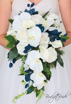 a bride holding a bouquet of white and blue flowers