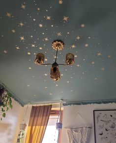 the ceiling is decorated with stars and hanging lights above it, along with pictures on the wall