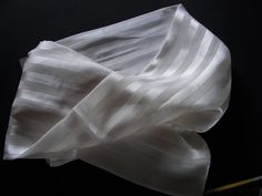 An unusual silk scarf with satin stripes 11 to wear or paint. In addition to chiffon and taffeta, silk fibers are often processed into satin silk. Satin is a shiny, fine type of fabric with a smooth upper side and a matt underside. In principle, satin can be woven from a wide variety of fibers, but if the endless natural fibers of silk are used, the result is a particularly shiny, elegant fabric with very good and pleasant properties.  Size: approx. 180 x 45 cm I send with Tracking nummer to 7,2 White Classic Silk Scarf, Classic White Silk Scarf, Classic Silk Scarf For Weddings, Classic White Silk Scarf For Gift, Classic Silk Scarf For Wedding, Elegant White Satin Silk Scarf, Elegant Fabric, Satin Silk, Natural Fibers