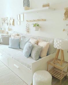 a white couch with many pillows on it