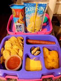 a plastic lunch box filled with fruit and snacks