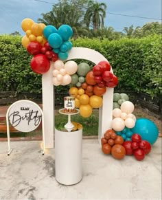 an arch decorated with balloons for a birthday party