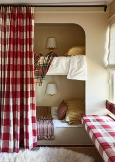 two bunk beds with red and white checkered curtains