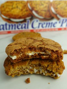 two cookies are stacked on top of each other in front of a box of oatmeal creme pies