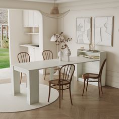 a dining room table with four chairs and a white rug on the floor in front of it