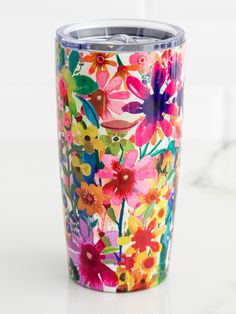 the colorful floral tumbler is sitting on the counter