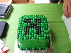 a green cake sitting on top of a table