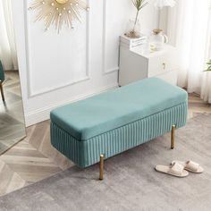 a blue bench sitting on top of a rug in front of a white door and mirror