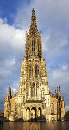 a large building with a clock tower on it's side and sky in the background