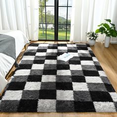 a black and white checkered rug in a bedroom