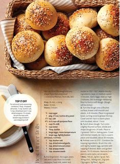 a basket filled with small buns sitting on top of a table next to a spoon