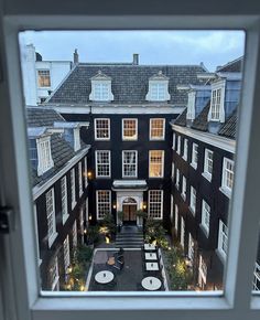 an aerial view of a courtyard from the window in a room with many windows on each side