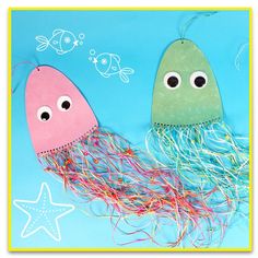 two paper jellyfishs with eyes and hair on a blue background next to a starfish