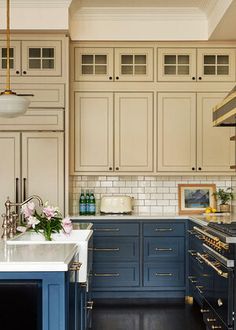 a kitchen with blue cabinets and white counter tops