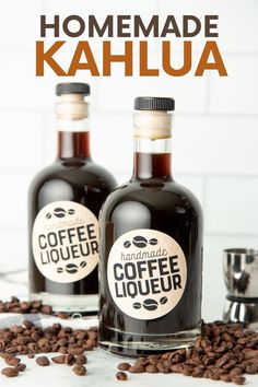 two bottles of coffee liqueur sitting on top of coffee beans