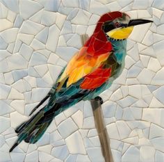 a colorful bird sitting on top of a piece of art made out of mosaic tiles