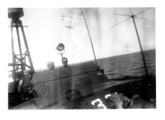 an old black and white photo of the front end of a boat in the water