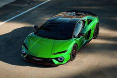 a green sports car is parked on the street