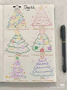 a notebook with christmas trees drawn on it