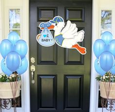 a stork welcomes the new baby with balloons in front of a door