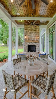 an outdoor dining table and chairs on a patio with a fire place in the background