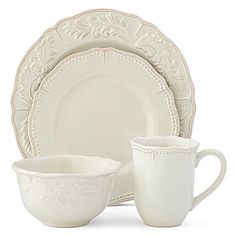 a white dinner set with two cups and saucers