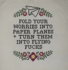 a cross stitch sample with the words fold your worries into paper planes turn them into flying fockes