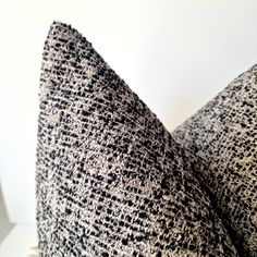 a black and white pillow sitting on top of a table