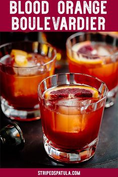 two glasses filled with blood orange punch on top of a table