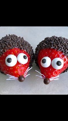 two chocolate covered strawberries with googly eyes