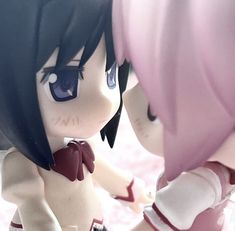 two anime dolls are touching each other's butts in front of a mirror