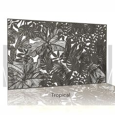 an intricate laser cut card with tropical leaves