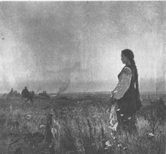 an old black and white photo of a woman standing in a field