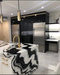 a modern kitchen with marble counter tops and black cabinets, along with an island in the middle