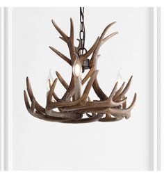 a chandelier with antlers hanging from it's sides and three lights on each side