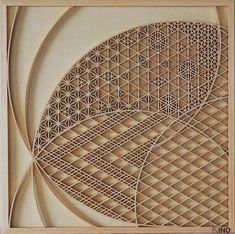 an intricately carved wooden artwork with geometric shapes and lines in the center, on a white background