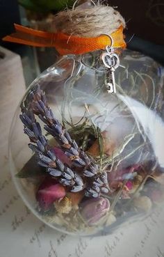 an ornament filled with dried flowers on top of a table