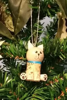 a cat ornament hanging from a christmas tree