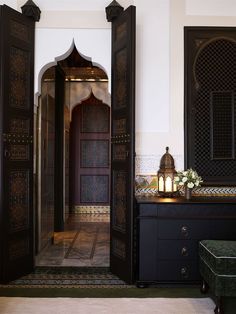 an open door leading to a bathroom with a bench