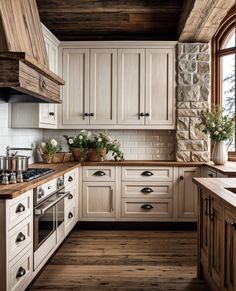 a kitchen with white cabinets and wood floors is pictured in this image, there are flowers on the counter