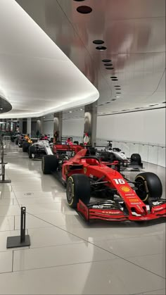 a red race car is on display in the lobby