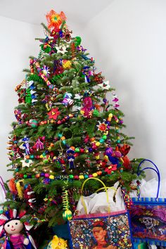 a brightly colored christmas tree with presents under it