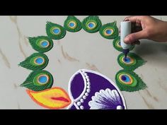 someone is painting peacock feathers on the floor