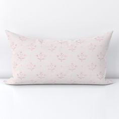 a white pillow with pink flowers on it